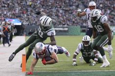 a football player dives for the ball during a game