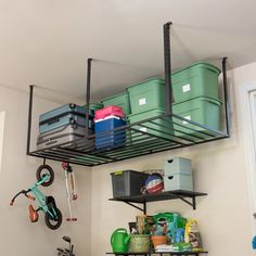 there is a bike and other items on the shelves in this garage storage area,