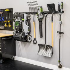 an organized garage with tools hanging on the wall