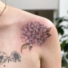 a close up of a person's chest with flowers on it