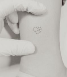 a person with a heart tattoo on their arm