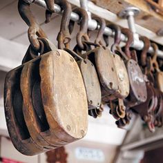 an assortment of wooden objects hanging from hooks