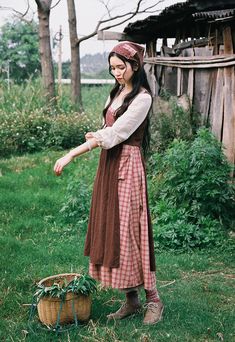 Early 19th century inspired village dress for everyday chores. This faux multi-layered dress features a white blouse part with a scoop neckline and three-quarter blouson sleeves, and a pinafore dress with plaid and ditsy floral patchwork layers. We've deliberately designed the floral patchwork to slant towards one side and attached it with an adjustable lace-up. There's a little pocket dangling at the waist to keep your phone or other knick-knacks. Full knit plaid skirt and partial linen brown s Pioneer Inspired Outfits, House Keeper Outfit, Victorian Peasant Clothing, Layered Dresses Outfit, Patchwork Dress Outfit, Cotton Cottagecore Prairie Dress For Fall, Cottagecore Style Cotton Vintage Dress For Fall, Cottagecore Cotton Prairie Dress For Fall, Cottagecore Prairie Dress For Gatherings