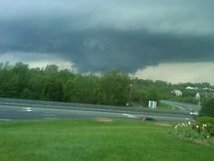 a large storm moving across the sky over a highway