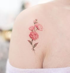 a woman's shoulder with pink flowers on it