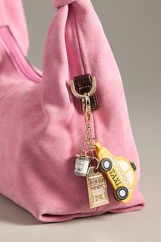 Charming new-trend alert: jewelry for your bag. Showcasing memorable motifs from your favorite cities, this adorable accessory can double as a bag charm and a key chain. | City Bag Charm by Anthropologie in Yellow, Women's, Polyurethane/Zinc Rectangular Travel Bag With Keychain, Rectangular Logo Bag Charm, Rectangular Bag Charm With Lobster Clasp For Everyday Use, Spring Bags 2024, Bag Quotes Handbags, Purse Accessories Ideas, Bag Charms Ideas, Bag Trends 2024, Bag Charm Trend 2024