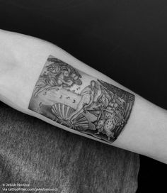 a black and white photo of a tattoo on the arm