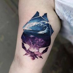 a man's arm with a tattoo on it that has an image of a shark in