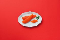 two pieces of carrots on a white plate