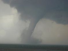 a large tornado is seen in the distance