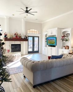 a living room filled with furniture and a christmas tree