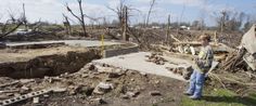 a man standing next to a pile of rubble