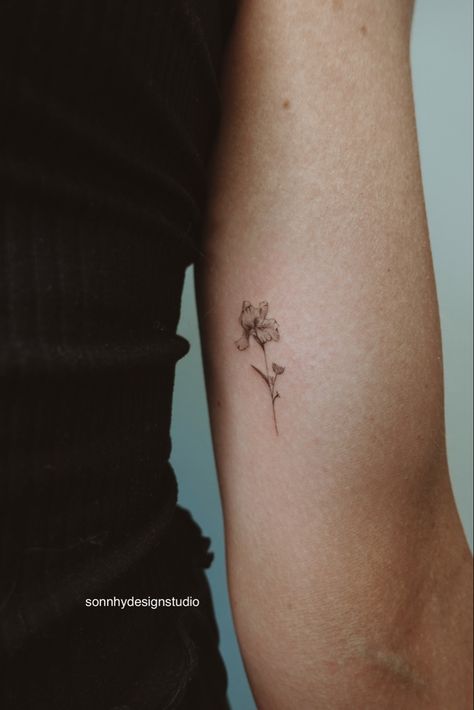 Inner Bicep Fine Line Tattoo, Delicate Iris Tattoo, Tiny Flower Hand Tattoo, Iris Hip Tattoo, Flower Iris Tattoo, Microrealism Tattoo Flower, Small Fine Art Tattoo, Minimalist Iris Flower Tattoo, Bicep Fine Line Tattoo