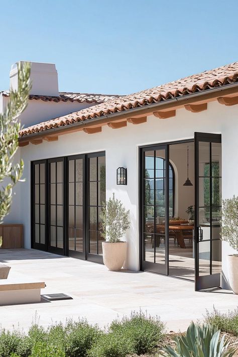 Modern spanish villa courtyard French doors. Check out all of these hacienda houses that blend rustic charm with modern comfort. Spanish Style Covered Patio, Modern Spanish Farmhouse Exterior, Modern Spanish Colonial Exterior, Spanish Modern Villa, House Mediterranean Modern, French House Architecture, French Door To Backyard, Mexican Modern House Exterior, Spanish Home Courtyard