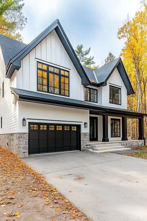 Modern cottage house with white siding stone brick foundation black trim black multi pitched roof modern windows with black and white trim large. Ever wondered how white exterior houses manage to look both timeless and incredibly chic? Dark Siding White Windows, Modern Farmhouse With Brick, White Exterior Homes, White Houses With Black Trim, Black And White House Exterior, Dark Exterior House Colors, Brick Foundation, Dark Exterior House, Paint 2024