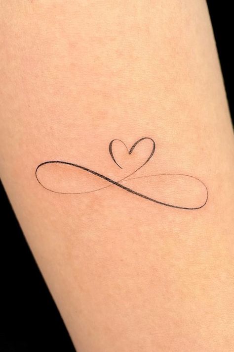 35 Stunning Small Heart Tattoo Ideas Heart Tattoo On Heart, Elegant Heart Tattoos, Red Infinity Tattoo, Forever Love Tattoo Symbols, Infinity And Heart Tattoo, Heart Dates Tattoo, Small Infinity Tattoos For Women, Hart Tattoo Small, Everlasting Love Tattoo