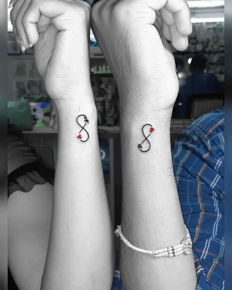 Matching infinity tattoo designs for couples who want to claim their love for each other. Cute, minimalistic couple tattoo ideas. Cute Boyfriend Tattoo Ideas, Couples Mini Tattoos, Gaming Couple Tattoos, Stronger Together Tattoo, Wifes Name Tattoo Ideas For Men, Marriage Tattoos Husband Wife, Infinity Matching Tattoos, Tiny Couples Tattoos, Tattoo Ideas Matching Couple