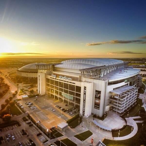 an aerial view of a stadium at sunset