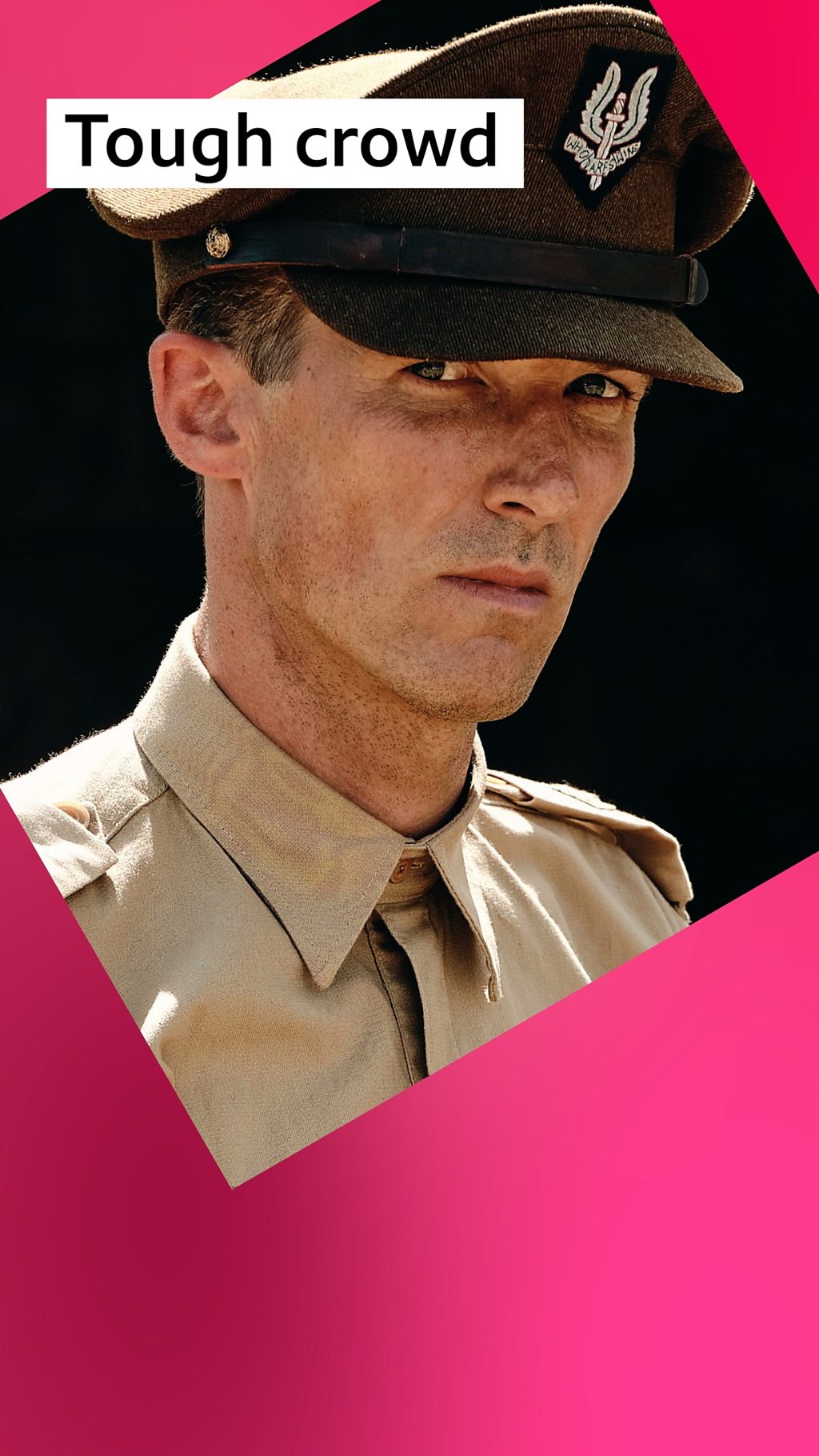 The character Lt Col William Stirling in military uniform, wearing a dark brown cap and camel shirt