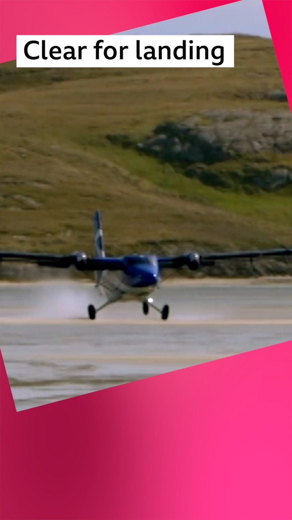 A small blue propeller plane touches down on the beach. Text reads Clear for landing