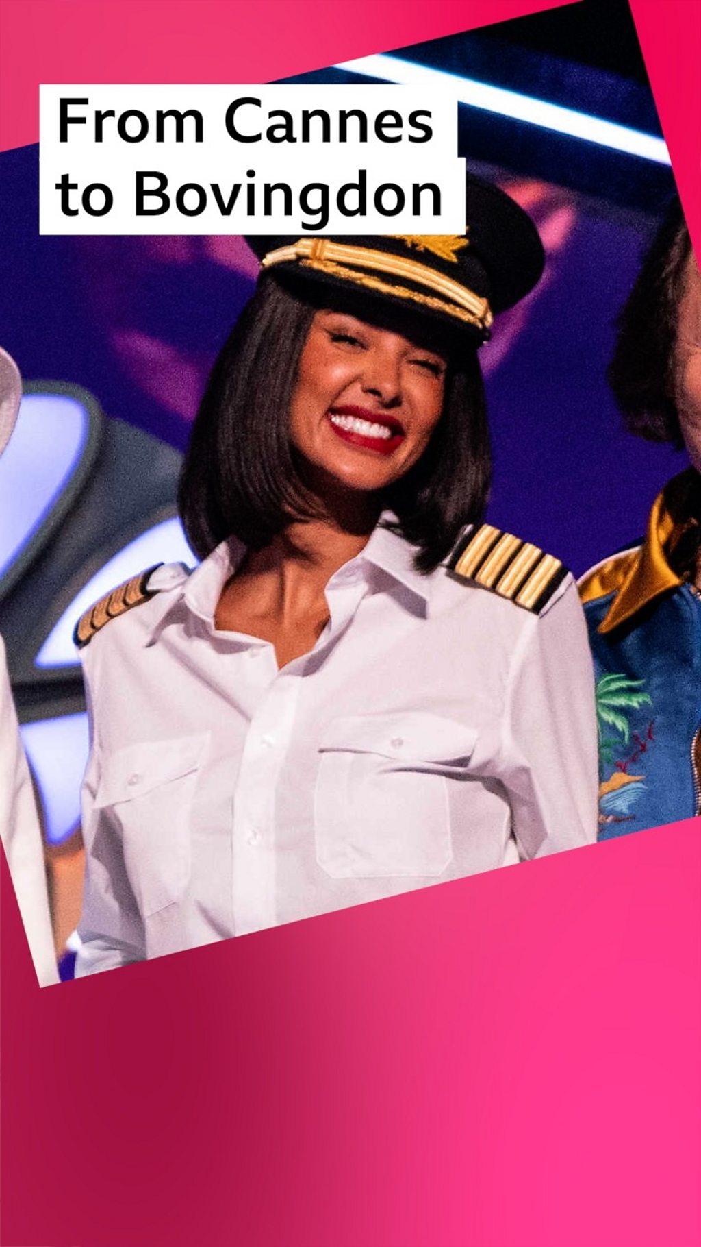 Maya Jama wears a pilot uniform and smiles at the camera