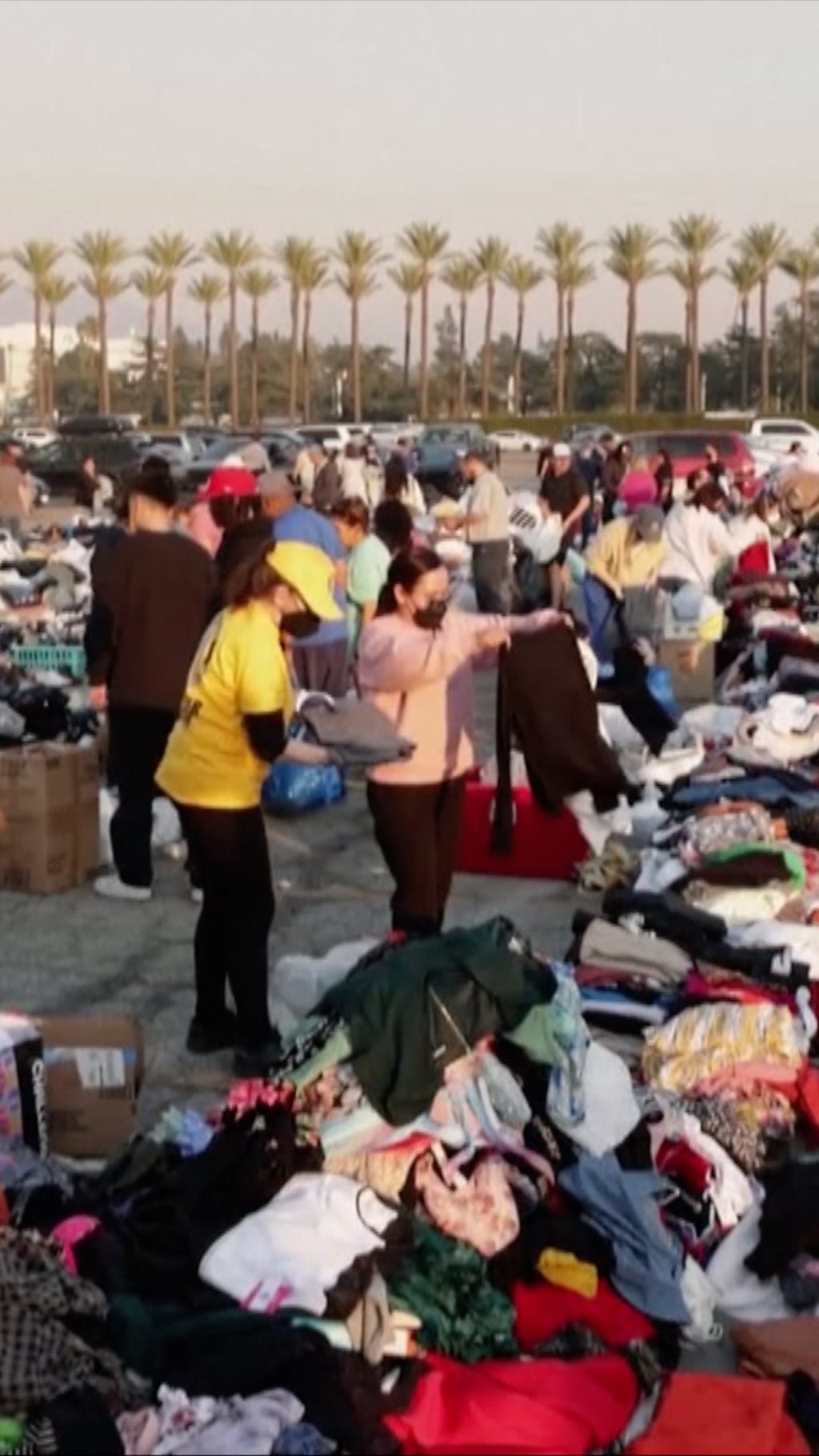 People in the street getting donated clothes