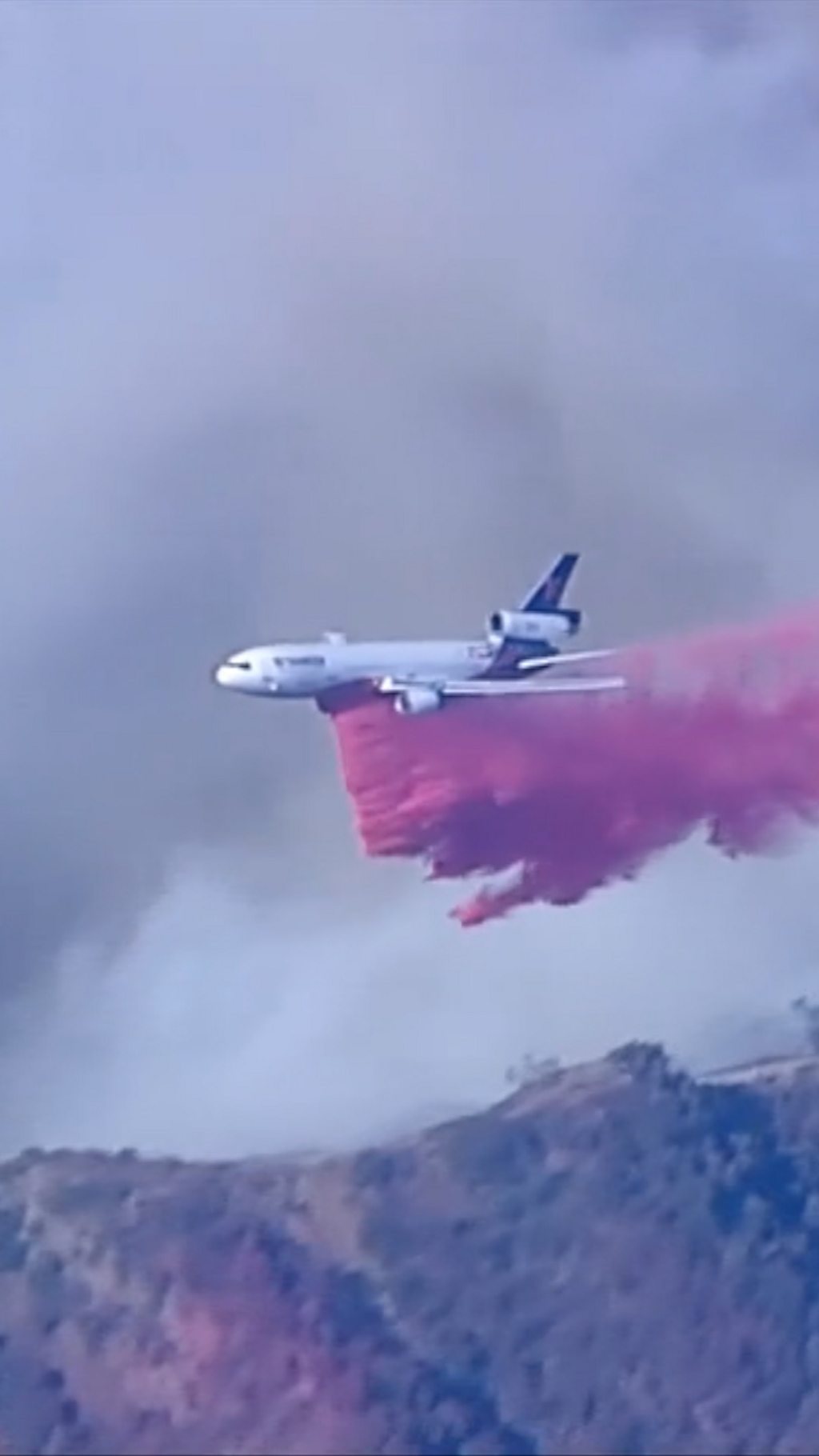 A plane dropping flame retardant