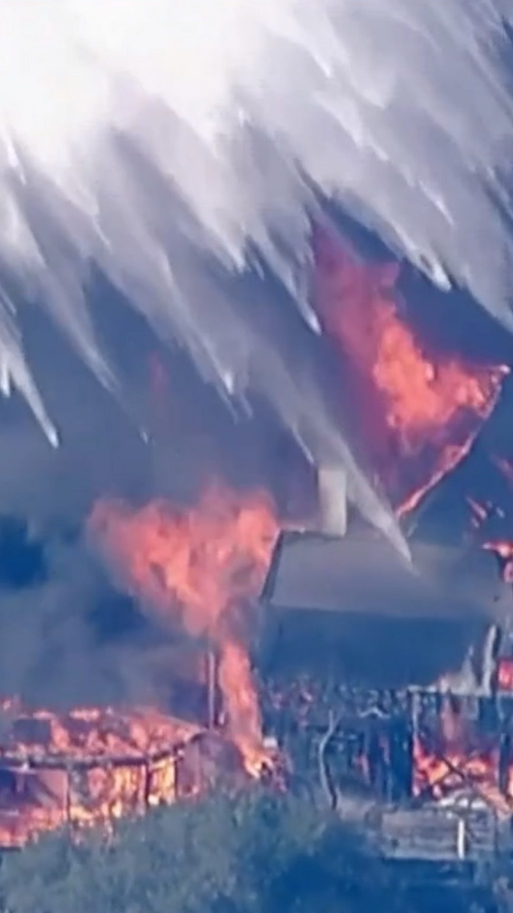 Helicopter douses water over house inferno