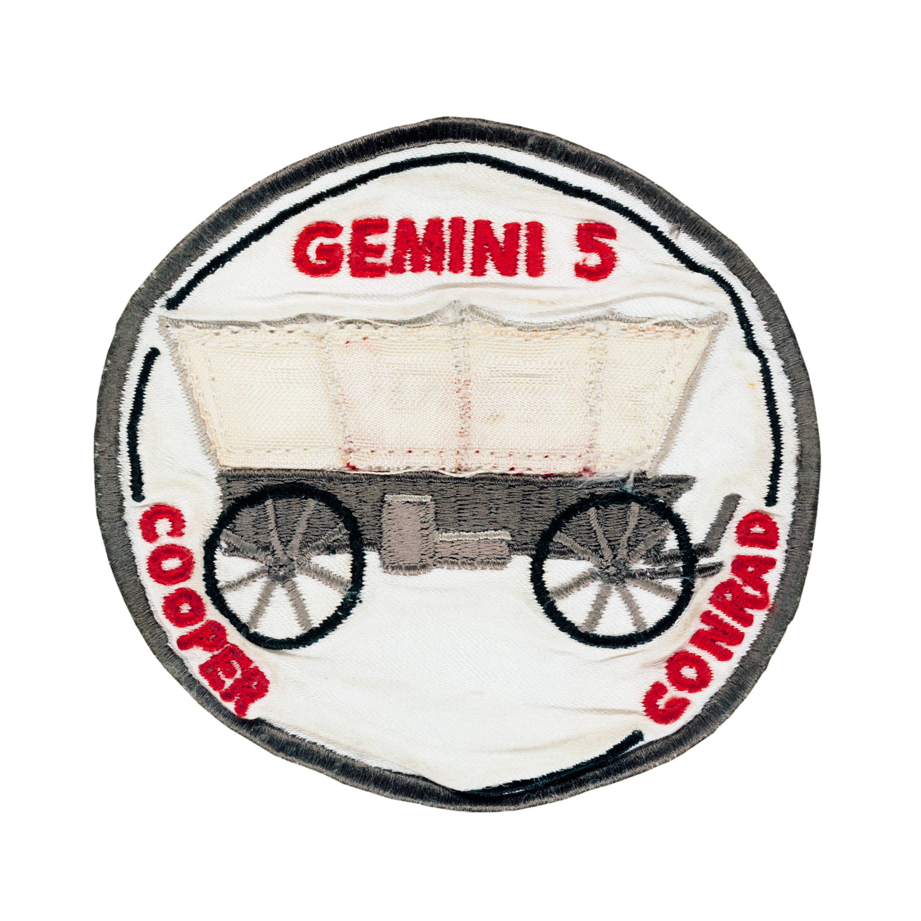 Gemini 5 mission patch showing an old wagon with the words Gemini 5, Cooper and Conrad