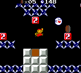 A screenshot of World 1-4 (VS Game) in Super Mario Bros. Deluxe, showing, among other things, Small Mario, a Boo, Face Blocks, and Spike Traps.