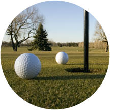 golf balls next to the hole on a golf course