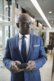 Man in suit holding cell phone