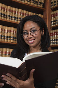 woman in glasses holding an open book