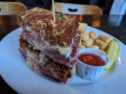 Photo of Murphy's Pub - Seattle, WA, US. a grilled meat sandwich with a side of tater tots