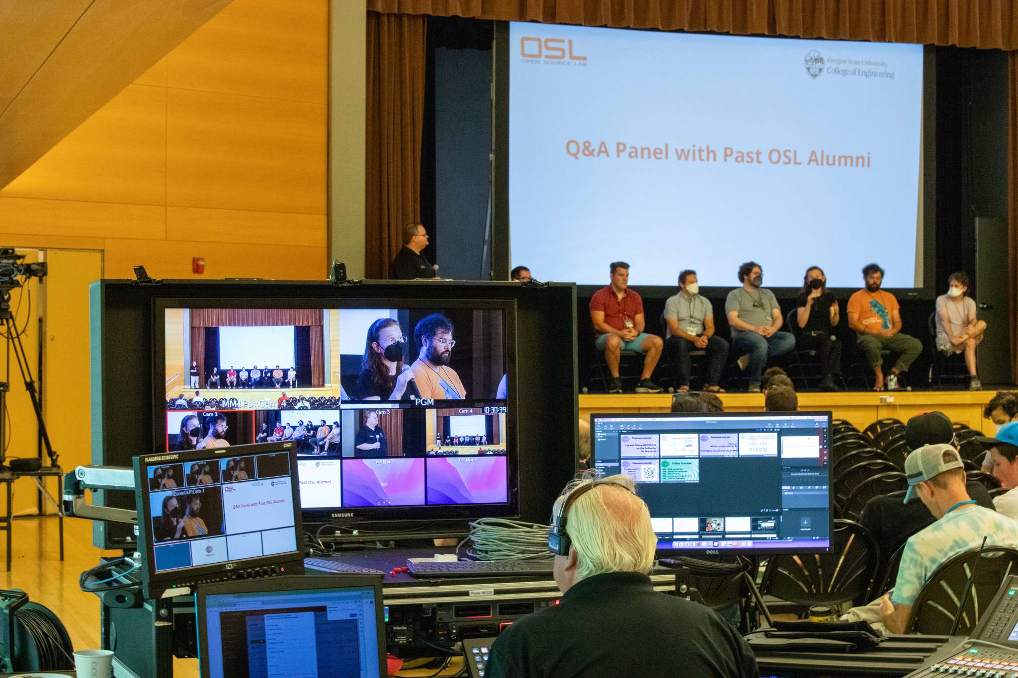 Picture of AV team with panel sitting on stage at FOSSY