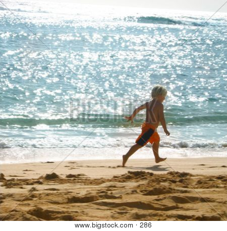 Boy Running Along Seashore