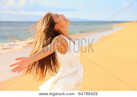 Free happy woman on beach enjoying nature. Natural beauty girl outdoor in freedom enjoyment concept. Mixed race Caucasian Asian girl posing on travel vacation holidays in dress.