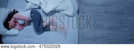 Woman With Rls - Restless Legs Syndrome. Sleeping In Bed