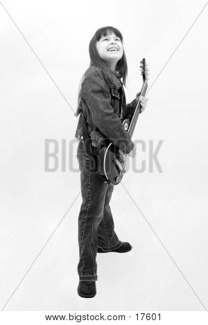 Child Playing Electric Guitar In Black & White